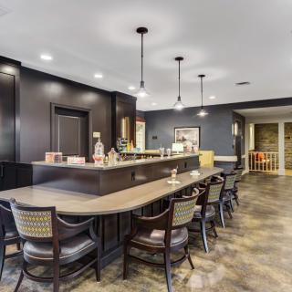 A modern bar interior featuring elegant seating and ambient lighting.