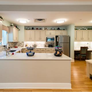 A modern kitchen with a center island and stainless steel appliances.