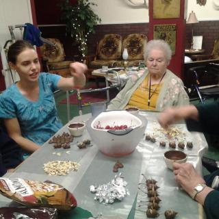 A group of people enjoying snacks and socializing indoors.