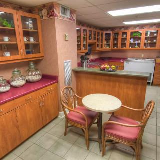 A cozy kitchen with wooden cabinets and a small dining table.