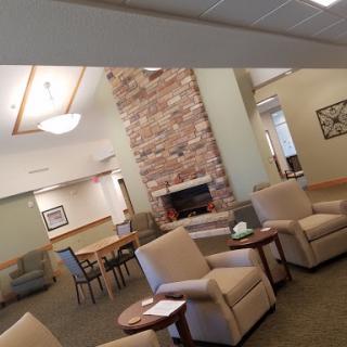 A cozy lounge area featuring comfortable seating and a warm fireplace, perfect for gatherings.