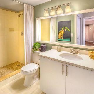 A modern bathroom featuring a sink, toilet, shower, and stylish decor.