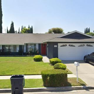 A suburban house with a well-maintained front yard and a driveway leading to the garage.