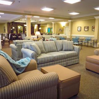 A spacious lobby with comfortable seating arrangements and warm lighting.