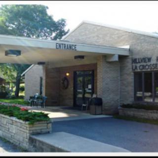 Exterior view of a library entrance with surrounding greenery.