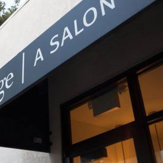An exterior view of a salon with its signage displayed.