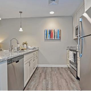 A modern kitchen with stainless steel appliances and a sleek design.