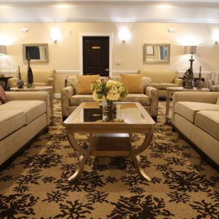 A cozy living room featuring elegant sofas, a stylish coffee table, and warm lighting.