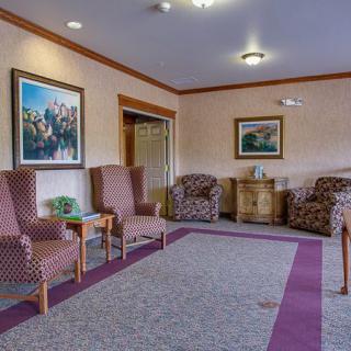 A cozy living room with comfortable seating and decorative artwork on the walls.