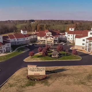 Aerial view of a residential complex with landscaped gardens and driveways.