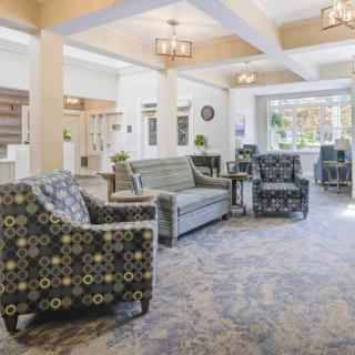 A spacious and well-lit lobby with comfortable seating arrangements, including sofas and chairs.