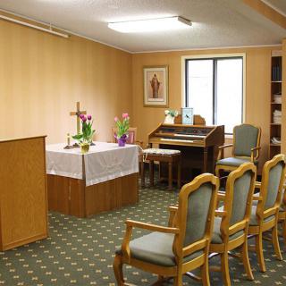 A small chapel with an altar and seating.