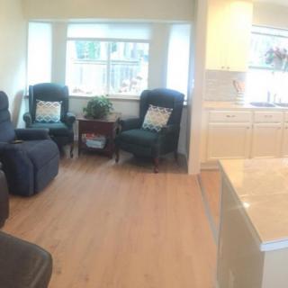 A cozy living room with comfortable chairs and abundant natural light.