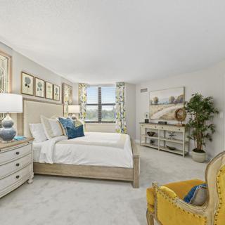 A beautifully designed bedroom with elegant decor and a large window.
