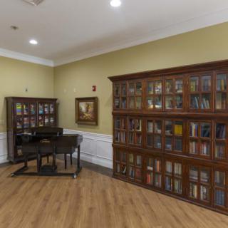 A quiet reading room with wooden bookshelves filled with books and a desk.