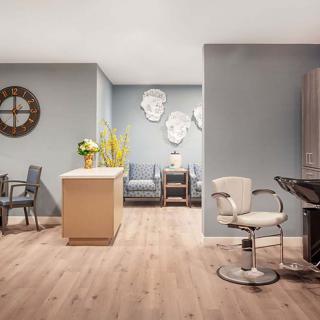 A modern salon interior with stylish decor and seating arrangements.