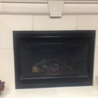 A cozy indoor fireplace with a tiled surround.