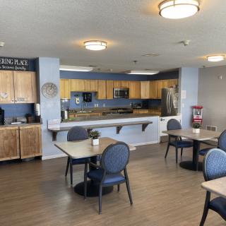 A communal kitchen and dining area with modern appliances and seating.