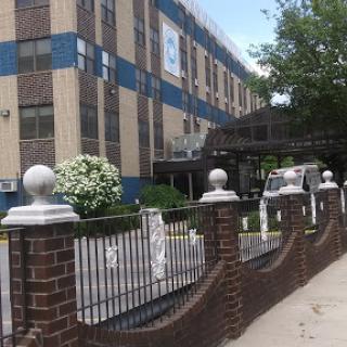 A view of a school building with landscaped surroundings.