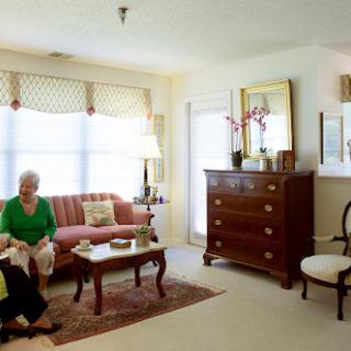 A cozy living room setting with people engaged in conversation.