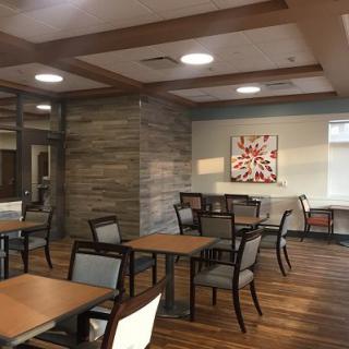 A modern dining area with wooden floors and stylish furniture.