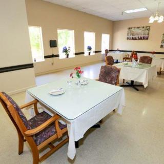 A bright and spacious dining area with neatly arranged tables and chairs.