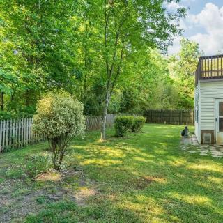 A peaceful backyard with lush greenery and a bordered fence.