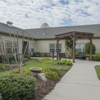 A landscaped courtyard with a pathway leading to a building entrance.