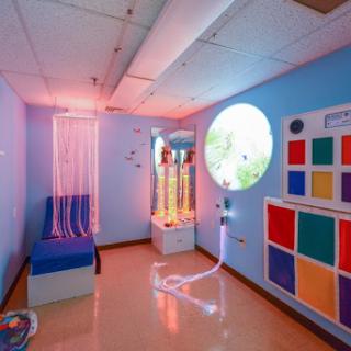 A serene therapy room designed to promote relaxation and sensory engagement.