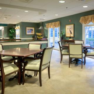 A well-appointed dining area with multiple tables and chairs, featuring a cozy and welcoming atmosphere.
