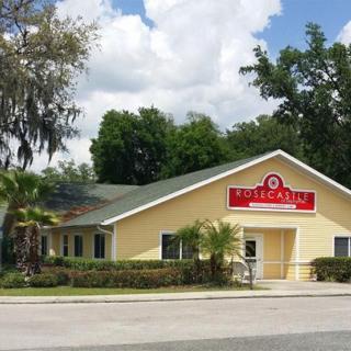 A restaurant building with prominent signage set against a cloudy sky backdrop.