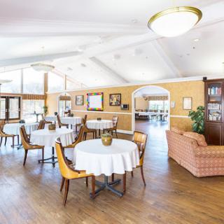 A beautifully arranged dining area featuring elegant tables and comfortable seating.