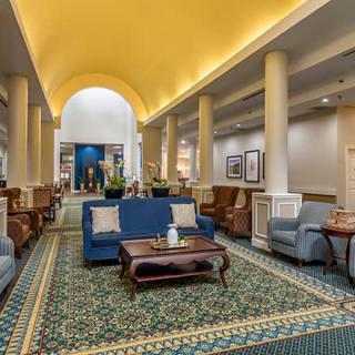 A spacious hotel lobby with comfortable seating and elegant decor.