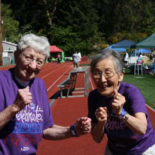 Two seniors enjoying an active day on the track.