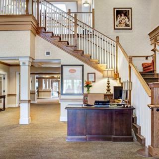 A welcoming lobby area featuring a reception desk and staircase.