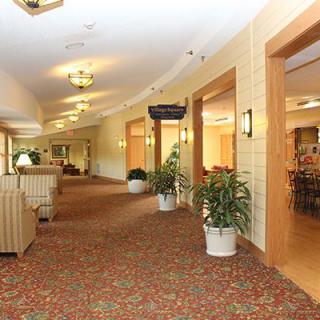 A spacious lobby featuring comfortable seating, decorative plants, and soft lighting.