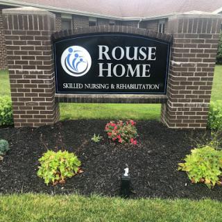 Entrance sign for Rouse Home, a facility offering skilled nursing and rehabilitation services.