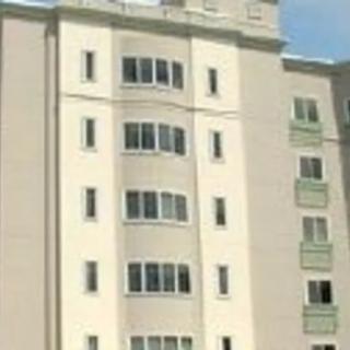 A multi-story apartment building with numerous windows.