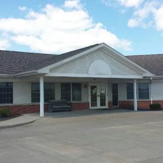 A single-story clinic building with a brick facade and white columns.
