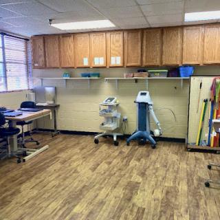 A spacious office area equipped with medical equipment and storage cabinets.