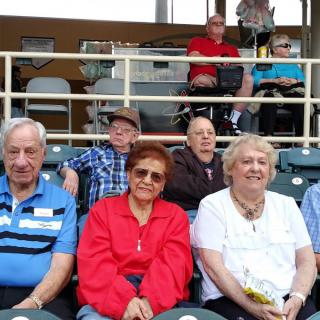 A group of people seated at an outdoor event.