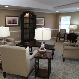A cozy living room with comfortable seating, elegant lamps, and tasteful decor.