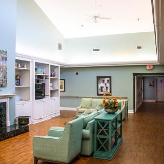 A modern lounge area with pastel-colored furniture and decorative items.