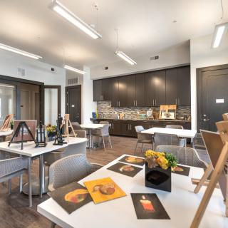 A well-lit art studio with easels and paintings on display.