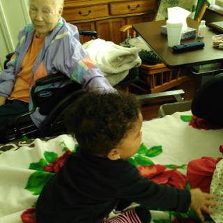 A heartwarming moment between an elderly woman and a child, showcasing the bond across generations.