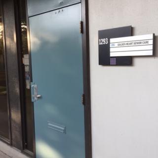 An exterior view of a blue door with signage indicating office information.