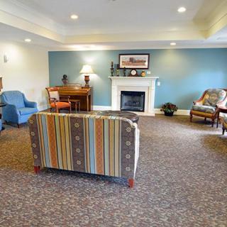 A cozy living room with a fireplace, comfortable seating, and tasteful decor.