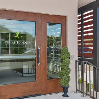 The elegant entrance featuring wooden doors and contemporary design.