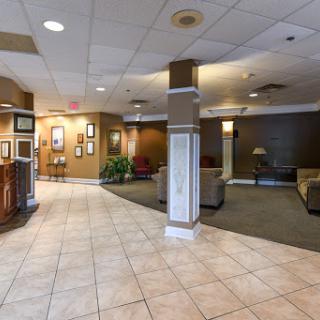 A spacious hotel lobby featuring comfortable seating areas, elegant decor, and a welcoming atmosphere.