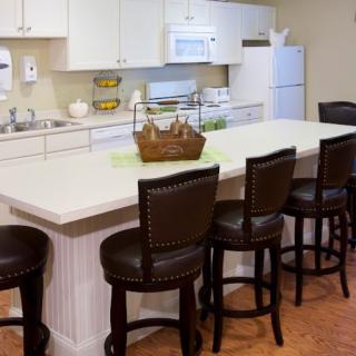 A modern kitchen with an island and bar stools.